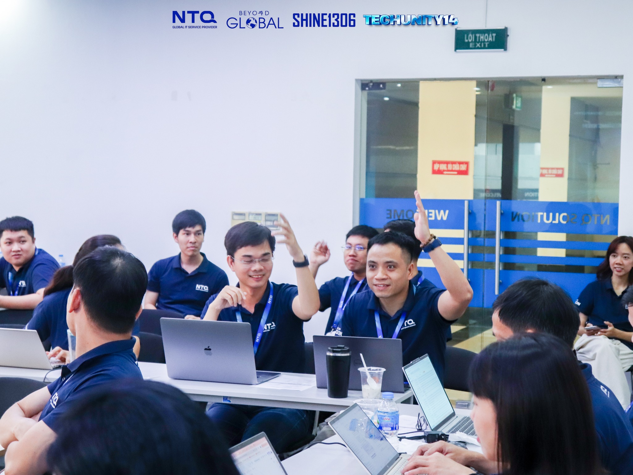 Excited members of Team 7 eagerly awaiting their turn to share their innovative idea.