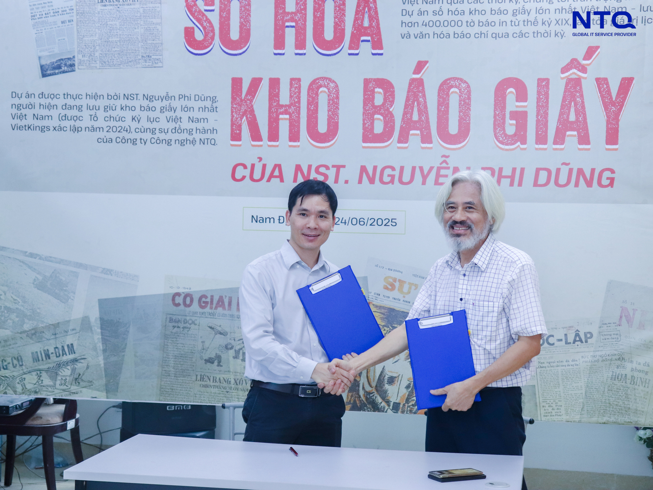 Mr. Bui Duc Chuong, NTQ's Co-founder & Project Lead and Mr. Nguyen Phi Dung at the signing table 